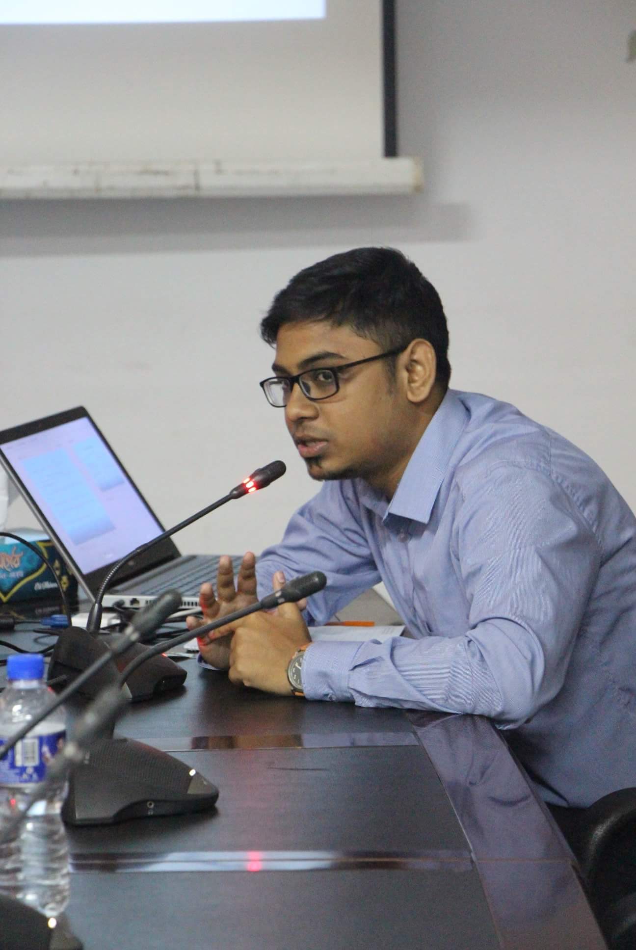 Rubiat Saimum speaking at a conference table